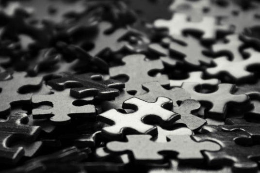 pile of black puzzle pieces symbolizing decision fatigue and complexity in choosing recovery tools and wellness gear