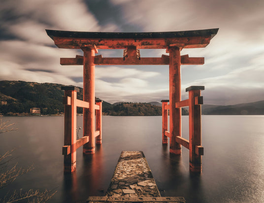 red and black tori gate in lake with rolling hills, representing daily rituals and recovery rituals philosophy